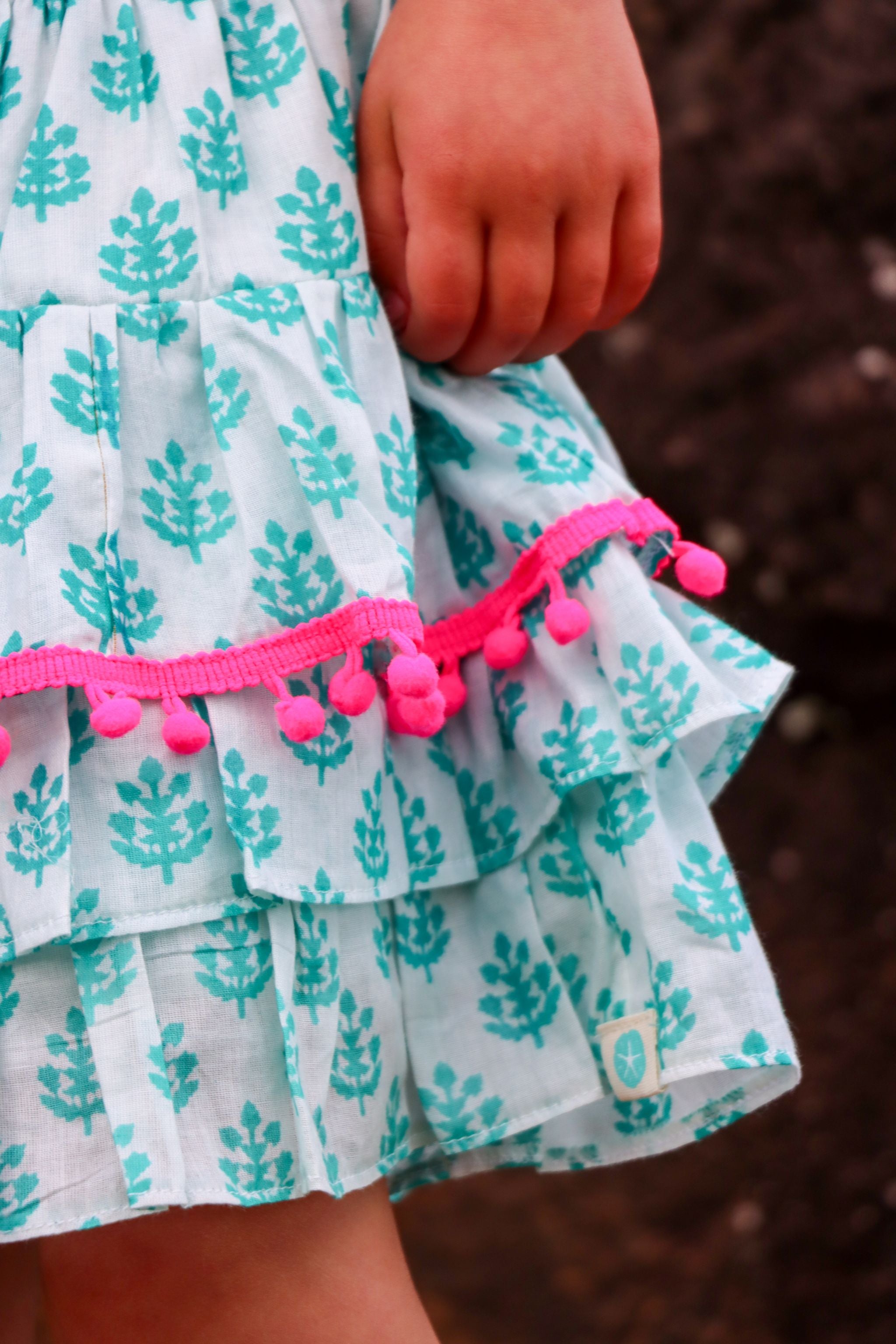 Rara Skort - sea holly with pink pompoms